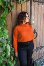 Portrait of carefree young woman smiling with urban background. Cheerful latin girl wearing eyeglasses in the city Royalty Free Stock Photo