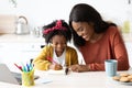 Portrait Of Caring Black Mom Helping Her Little Daughter With Homework Royalty Free Stock Photo