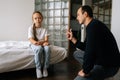 Portrait of caring young father having serious conversation with naughty spoiled female child, talking about rules to Royalty Free Stock Photo