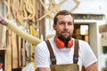 Portrait of a carpenter in work clothes and hearing protection i Royalty Free Stock Photo