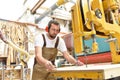 portrait of a carpenter in work clothes and hearing protection in the workshop of a carpenter\'s shop Royalty Free Stock Photo