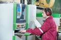 Portrait of carpentry worker with CNC machine