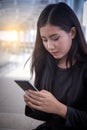 Young woman using smartphone send a text message. Royalty Free Stock Photo