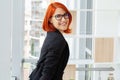 Portrait of a casual businesswoman with short red hair in a modern house. Royalty Free Stock Photo