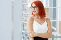 Portrait of a casual businesswoman with short red hair in a modern house. Royalty Free Stock Photo