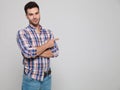 Portrait of casual man wearing plaid shirt pointing to side Royalty Free Stock Photo