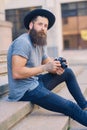 Street photographer sits on a step.