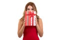 Portrait of casual young happy smiling woman hold red gift box. Isolated studio background female model. Royalty Free Stock Photo