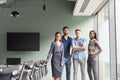 Portrait Of Casually Dressed Businessmen And Businesswomen Having Informal Meeting In Modern Boardroom Royalty Free Stock Photo