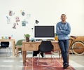 Lets get to work. Portrait of a casually-dressed young man sitting on his desk in an office. Royalty Free Stock Photo