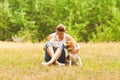 Portrait of cat and dog`s interaction in their owner arms