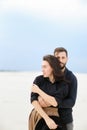 Portrait of caucasain man hugging woman in monophonic background. Royalty Free Stock Photo