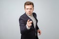 Portrait of caucasian angry young man in suit pointing finger at you Royalty Free Stock Photo