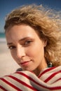 Beautiful woman wrapped in towel standing on the beach Royalty Free Stock Photo