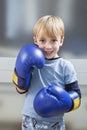 Portrait of Caucasian boy in casuals wearing boxing gloves Royalty Free Stock Photo