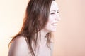 Portrait of Caucasian Brunette Girl with Shining Skin.Posing Against Yelowish Background