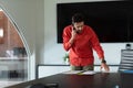 Portrait of caucasian businessman standing in meeting room talking on smartphone Royalty Free Stock Photo