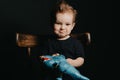 Portrait of a Caucasian child boy playing with dinosaur toys Royalty Free Stock Photo