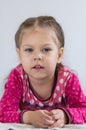 Portrait of caucasian child of three years old with calm look looking at camera on white background