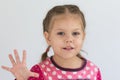 Portrait of caucasian child of three years old shows five fingers to show number five looking at camera on the white background Royalty Free Stock Photo