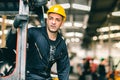 Portrait of Caucasian factory worker handsome smart with safety clothes and yellow helmet