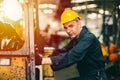 Portrait of Caucasian factory worker handsome smart with safety clothes and yellow helmet