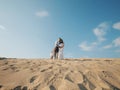 Portrait of caucasian family with baby in white clothes are standing on sands dune. Pregnant mpther. Newborn Royalty Free Stock Photo