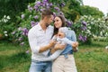 Portrait of a Caucasian family enjoying happy love, father and mother holding a cute little son in their arms, smiling, playing Royalty Free Stock Photo