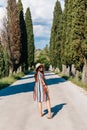 Portrait of a Caucasian female wearing a sun dress in the middle of a dirt road