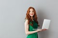 Portrait of caucasian ginger long haired woman in green dress lo Royalty Free Stock Photo