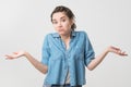 Portrait of caucasian girl with braids having doubtful and indecisive face expression.