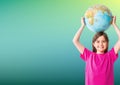 Portrait of caucasian girl holding a globe over her head against green gradient background Royalty Free Stock Photo