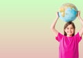 Portrait of caucasian girl holding a globe over her head against green and pink gradient background Royalty Free Stock Photo