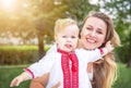 Portrait of caucasian happy baby (boy) in the ukrainian vyshyvanka shirt and his mother. Royalty Free Stock Photo