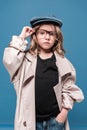 portrait of caucasian kid girl in glasses and oversized coat looking