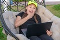 Portrait of caucasian little girl behind laptop computer in the park.Girl is surprised looking at the laptop. Emotions Royalty Free Stock Photo