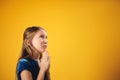 Portrait Of Caucasian Little Girl Praying God On Yellow Background Royalty Free Stock Photo