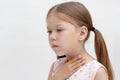 Child holding hand on throat