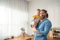 Portrait of Caucasian loving father hold baby boy child in living room. Happy family, attractive caring young dadd carry his Royalty Free Stock Photo