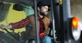 Portrait of caucasian male farmer in cap sitting in tractor with open door and smiling to camera. Agriculture farming. Royalty Free Stock Photo