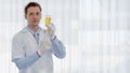 Portrait of caucasian male medical doctor in white lab coat with syringe and injection medicine on hands Royalty Free Stock Photo