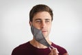 Portrait of caucasian man removing face mask against grey background Royalty Free Stock Photo