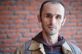 Portrait of a Caucasian man with stubbly beard and short hair with brown leather jacket Royalty Free Stock Photo