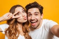 Portrait of caucasian man and woman taking selfie photo and show Royalty Free Stock Photo