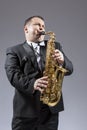 Portrait of Caucasian Mature Expressive Saxophone Player Playing the Instrument