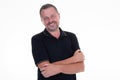 Portrait of caucasian mature middle-aged man in black shirt looking at camera and smiling isolated in white background Royalty Free Stock Photo