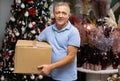 Portrait of man with pasteboard box in christmas market