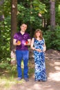 Portrait of a caucasian pregnant woman and her husband holding toys for baby outdoors Royalty Free Stock Photo