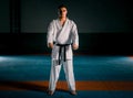 Karate martial arts fighter in white kimono in the gym