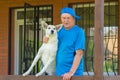 Portrait of  Caucasian senior man and his lovely mixed breed white young dog Royalty Free Stock Photo